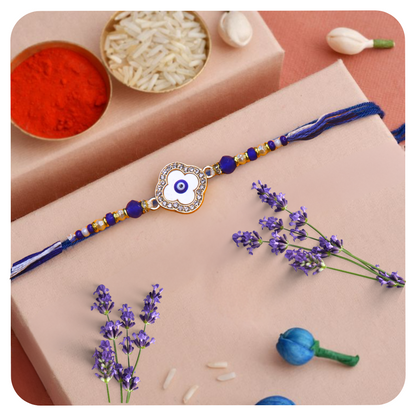 Vera Clover Evil Eye Rakhi for Brother – White Four-Leaf Evil Eye Motif with Blue Beads and Dual Thread – Handmade Rakhi for Raksha Bandhan