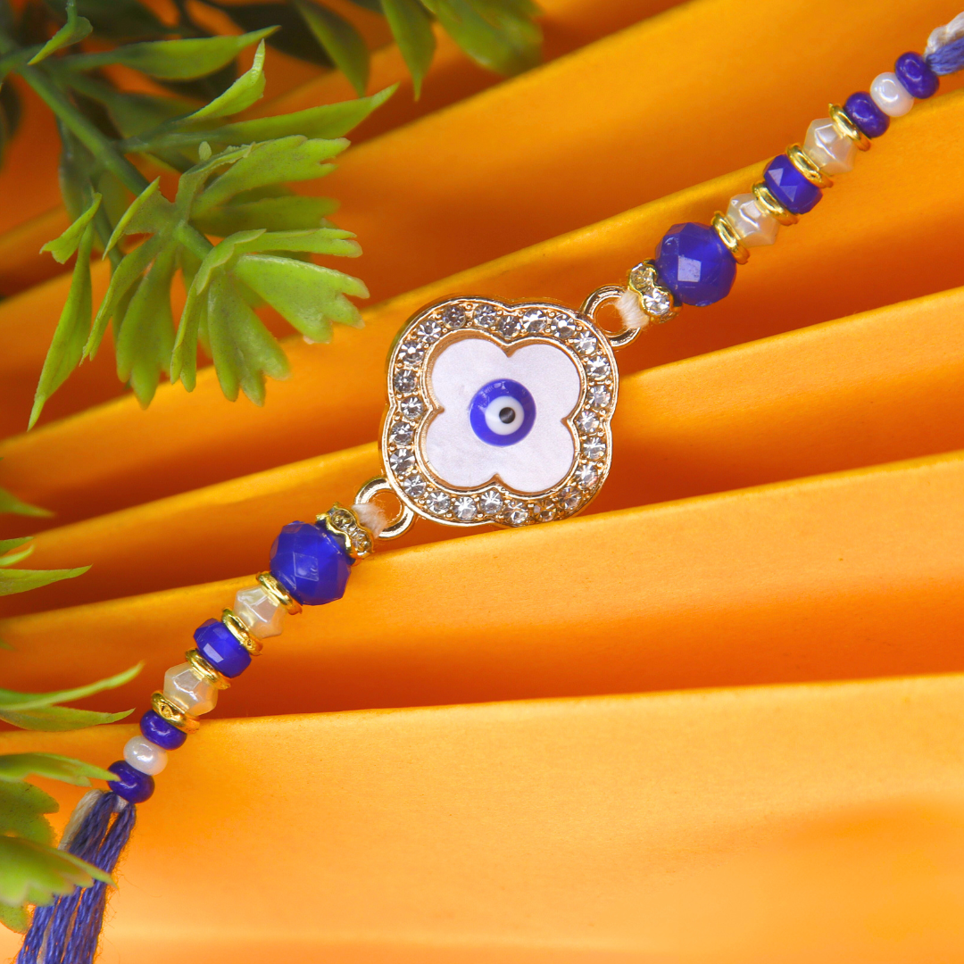 Vera Clover Evil Eye Rakhi for Brother – White Four-Leaf Evil Eye Motif with Blue Beads and Dual Thread – Handmade Rakhi for Raksha Bandhan
