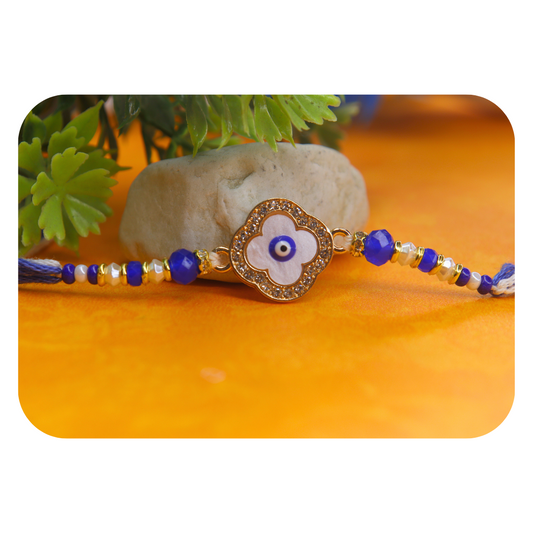 Vera Clover Evil Eye Rakhi for Brother – White Four-Leaf Evil Eye Motif with Blue Beads and Dual Thread – Handmade Rakhi for Raksha Bandhan